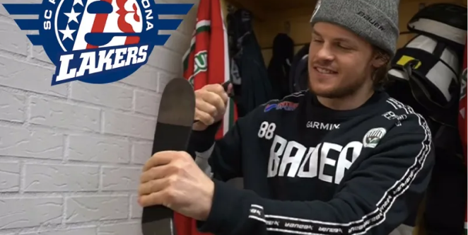 A male hockey player in the dressing room.